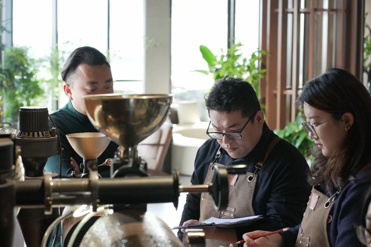 Coffee team recording roast profile notes during a study session