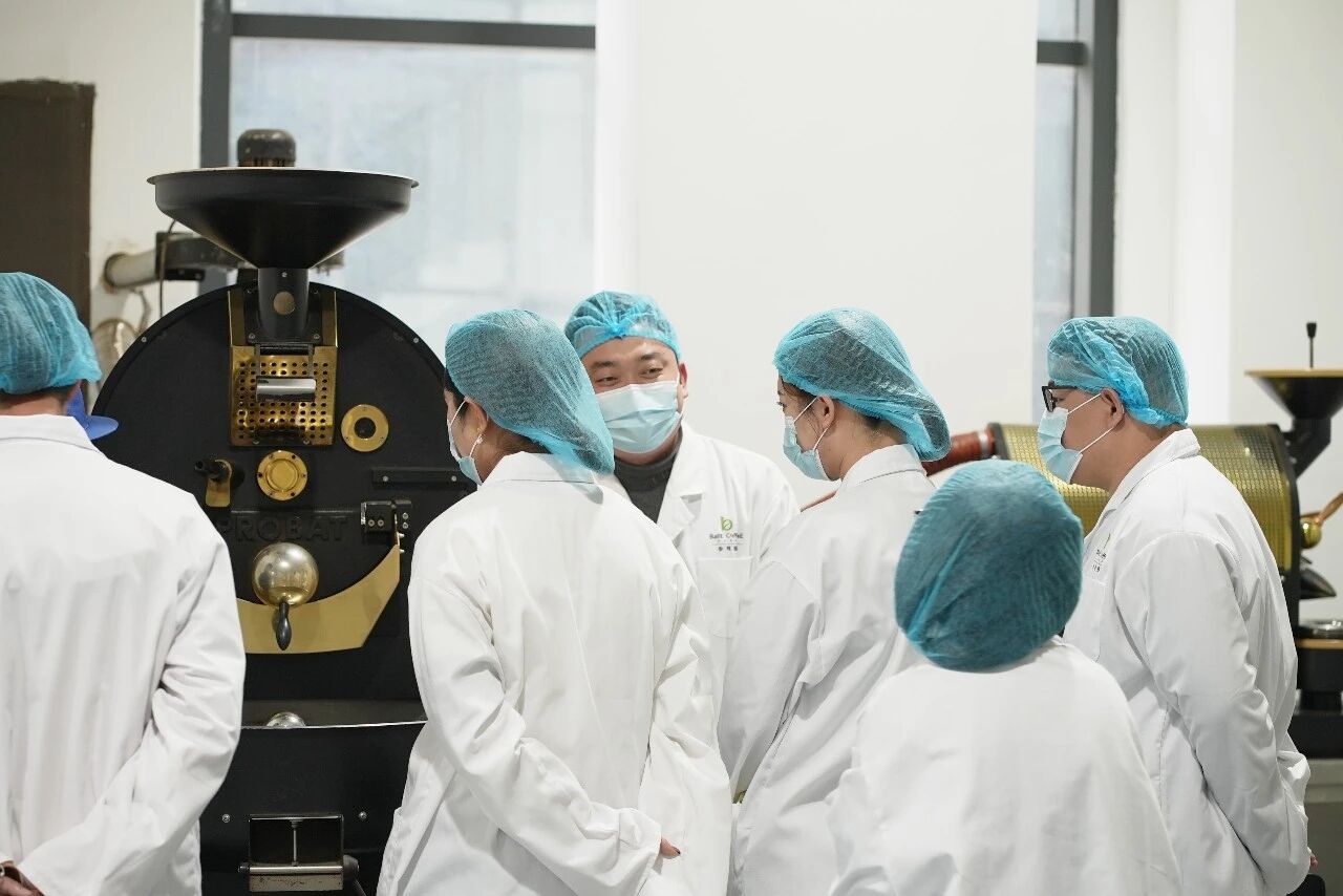 Production team reviewing roasting equipment together